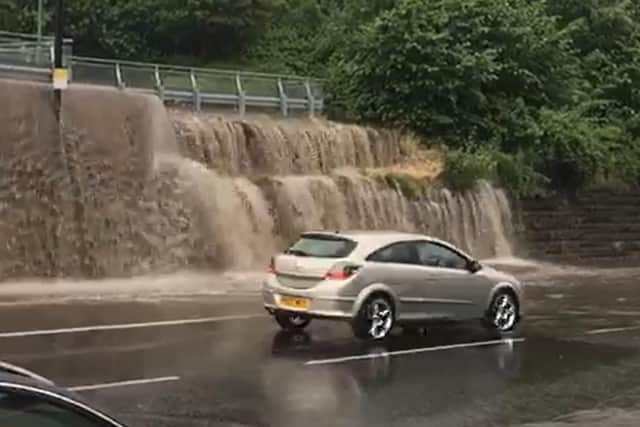 Dramatic footage taken by Ian Parkinson shows rainwater streaming out a nearby car park and onto Chesterfield Road.