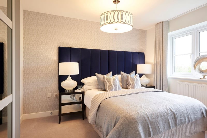 The Master Bedroom is sizeable and features an en-suite bathroom. There are opulent round lamps on the bedside tables and reflective drawer fronts, along with the mirrored doors of the fitted wardrobes, adding to the feeling of space.