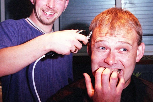 At Armthorpe Rugby Club in 1998 the manager of Doncaster Wildcats Paul Knapp right prepares to have his head shaved to raise money for the club by hairdresser Ady Moorhouse