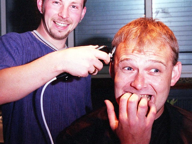At Armthorpe Rugby Club in 1998 the manager of Doncaster Wildcats Paul Knapp right prepares to have his head shaved to raise money for the club by hairdresser Ady Moorhouse