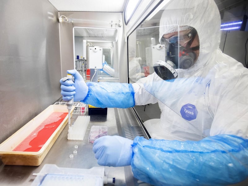 Dr Kieran Dee works in a Class II Microbiological Safety Cabinet with a sample of cultured cells that have been infected with SARS-CoV-2, the virus which causes COVID-19, to determine the genetic makeup of the virus