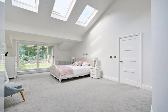 The master bedroom again has enormous windows and a lovely white finish, allowing natural light to reach every corner of the room.