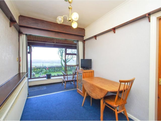 This dining room provides a pleasant space for meals, while also offering spectacular views over open fields at the back of the property.