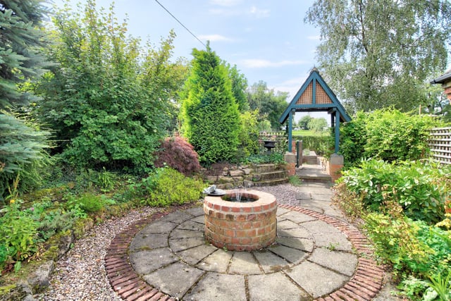 There is lawn areas, footpath and an English country garden area with water feature and station lighting.