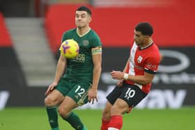 John Egan of Sheffield Utd challenges Che Adams of Southampton during the Premier League match at St Mary's Stadium, Southampton. David Klein/Sportimage