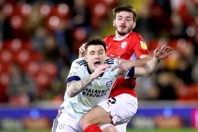 Cardiff City's Jordan Hugill (left) and Barnsley's Liam Kitching battle for the ball during the Sky Bet Championship match at Oakwell Stadium, Barnsley. Picture date: Wednesday February 2, 2022. PA Photo. See PA story SOCCER Barnsley. Photo credit should read: Isaac Parkin/PA Wire.

RESTRICTIONS: EDITORIAL USE ONLY No use with unauthorised audio, video, data, fixture lists, club/league logos or "live" services. Online in-match use limited to 120 images, no video emulation. No use in betting, games or single club/league/player publications.