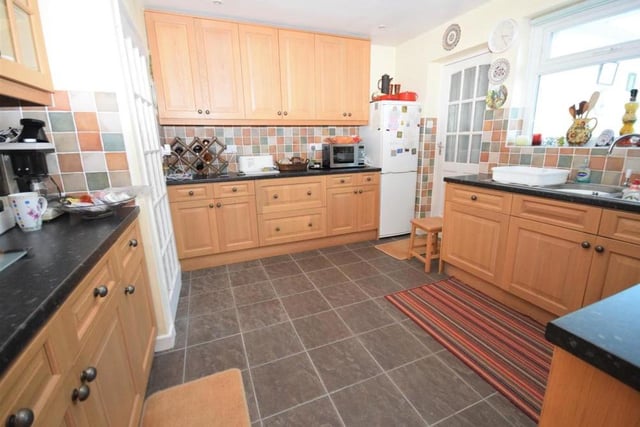The fully equipped kitchen is fitted with a range of wall and base units for plenty of storage.. There is a one-and-a-half bowl sink and drainer, an integral oven, four-ring gas hob with extractor above and a dishwasher.