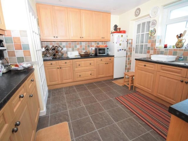 The fully equipped kitchen is fitted with a range of wall and base units for plenty of storage.. There is a one-and-a-half bowl sink and drainer, an integral oven, four-ring gas hob with extractor above and a dishwasher.