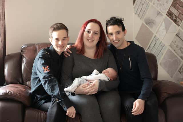 Harvey Cooper (r) and Adam Williams (l) with baby Jacob and surrogate Naomi (pic: SWNS.com)