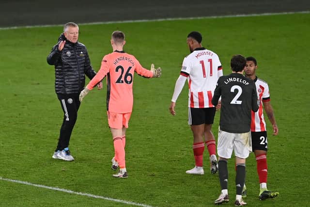Chris Wilder, manager of Sheffield United interacts with Dean Henderson of Manchester United following the Premier League match between Sheffield United and Manchester United at Bramall Lane on December 17, 2020 in Sheffield   (Photo by Laurence Griffiths/Getty Images)
