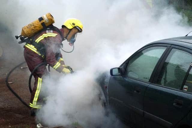A motorist had to get out of their car after it caught light at traffic lights on Herries Road, Sheffield. File picture shows a firefighter dealing with a previous car blaze