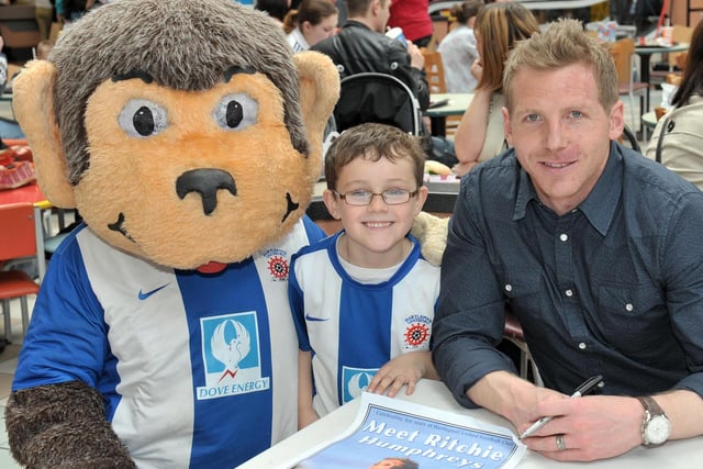 Young Pools fan George Bailey posed for a photograph with Ritchie Humphreys and H'Angus at a signing event in Middleton Grange in this picture from 2011. Picture by FRANK REID