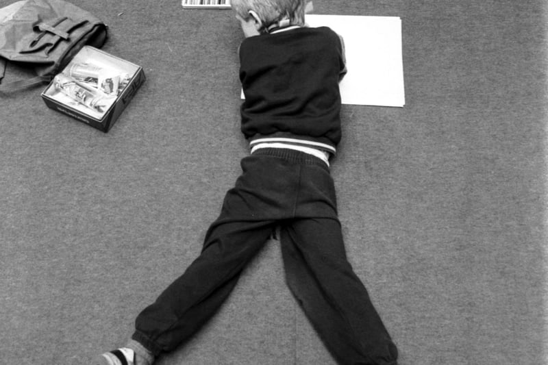 A little boy stretches out on the carpet at the annual Children's Art Competition held in the Royal Museum of Scotland in Edinburgh. Picture taken December 1988.