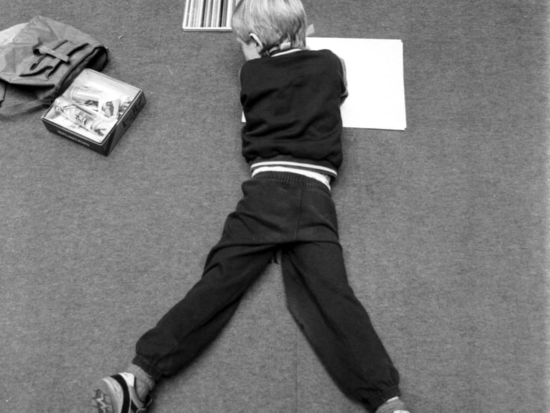 A little boy stretches out on the carpet at the annual Children's Art Competition held in the Royal Museum of Scotland in Edinburgh. Picture taken December 1988.