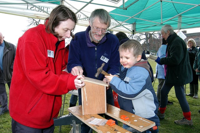 Sam Roberts, puts the finishing touches to a bird box, helped by Notts Wildlife Trust members Fran Taylor and Don Gunn, at Hodsock Priory in 2007.
