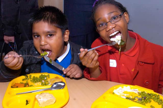 Mohamed Hasam and Sarah Zintchem, from Springfield school, tucking into their school dinners in 2011