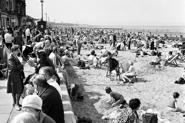Children and families enjoy the May sunshine on the beach and promenade at Portobello in 1975.