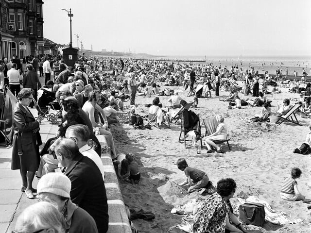 Children and families enjoy the May sunshine on the beach and promenade at Portobello in 1975.