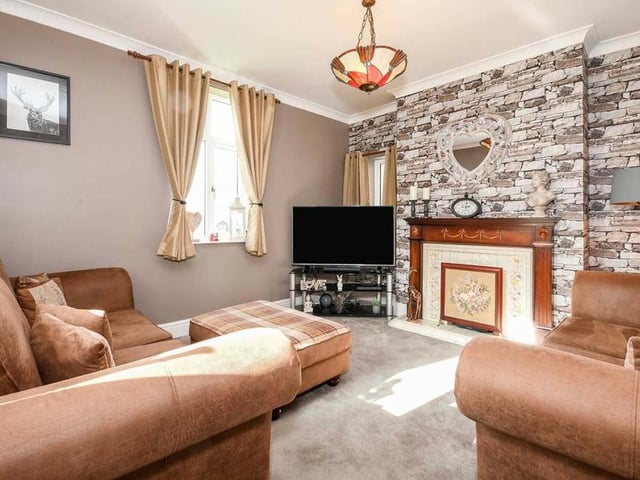 Here is one of the lovely reception rooms on the ground floor of Halfmoon House. Warm and cosy, it boasts an open grated fire and a uPVC double-glazed window.