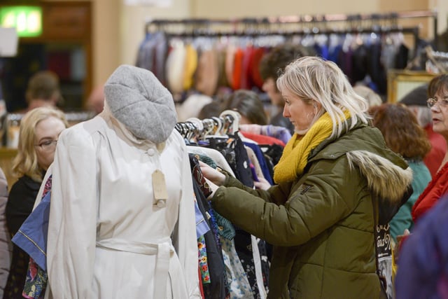 A shopper checks out some of the vintage clothing available
