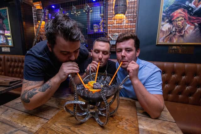 First customers Joe Smith, Max Winslade and Curtis Bell dive into a cocktail at Rapscallions. Picture: Habibur Rahman