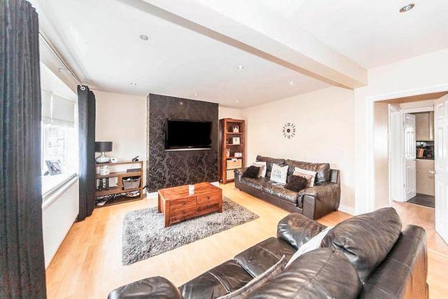 A spacious lounge is located to the front of the property and features laminate flooring and modern down light fittings.