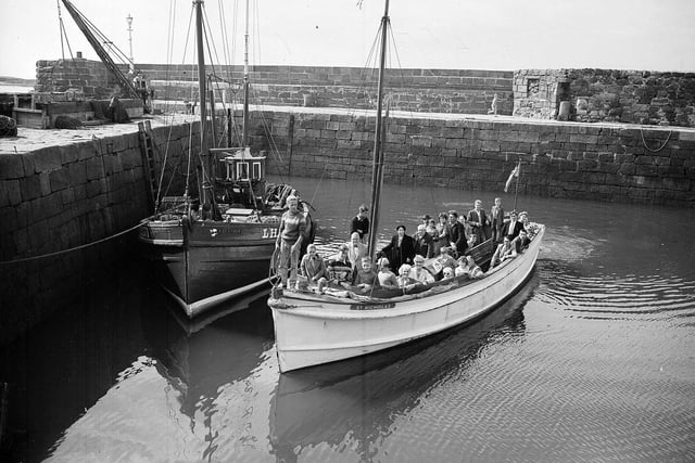 Holidaymakers in a boat preparing to depart from North Berwick Harbour in May 1962.
