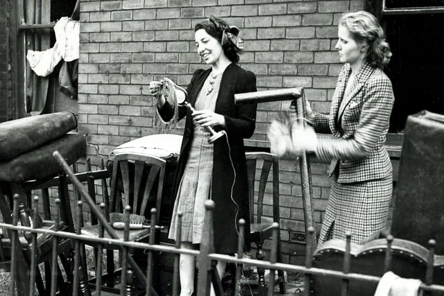 The war spirit prevails as these ladies clear up at Scott Road, Grimesthorpe, after the Sheffield Blitz in December 1940