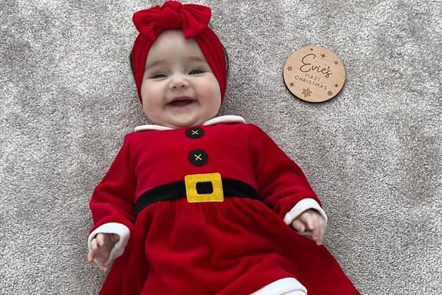 A big smile and a Christmas giggle from Evie.