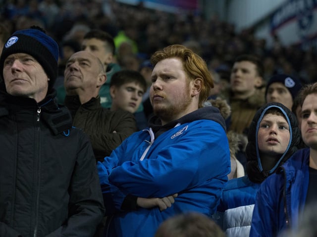 Pompey fans look disappointed as Arsenal score their second goal.