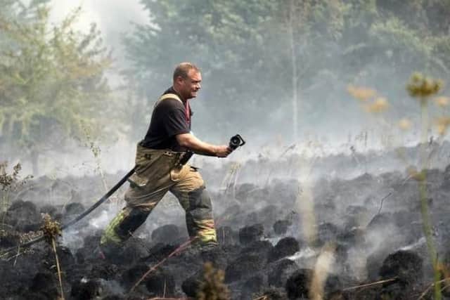 Nearly two dozen firefighters remain at Wharnecliffe Woods, near Oughtibridge, this morning, and are expected to remain there all day, according to fire service  bosses. PIcture shows firefighters at the scene. Picture: South Yorkshire Fire and Rescue