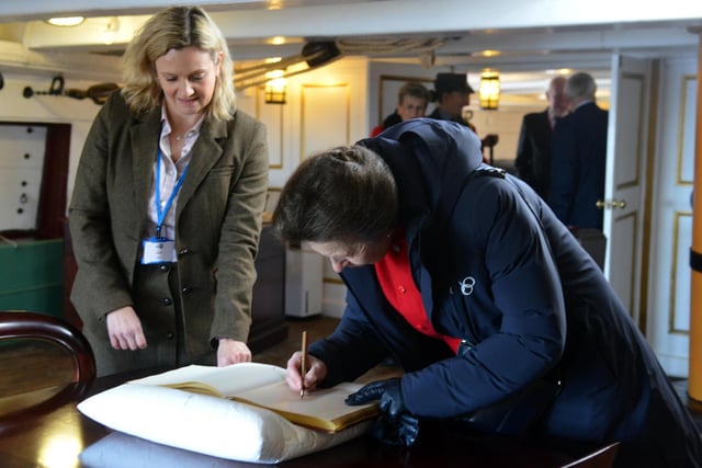 HRH Princess Anne The Princess Royal signs the visitors book aboard HMS Trincomalee.