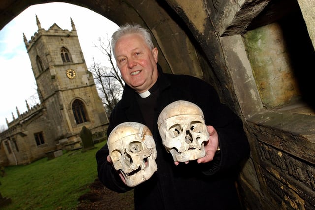 Pictured in 2005 with the two remaining Hickleton Church skulls is Canon Tony Delves, vicar at Hickleton. On the right is the area in the lych-gate where the three skulls were originally housed, and where the two remaining skulls were eventually be re-housed.