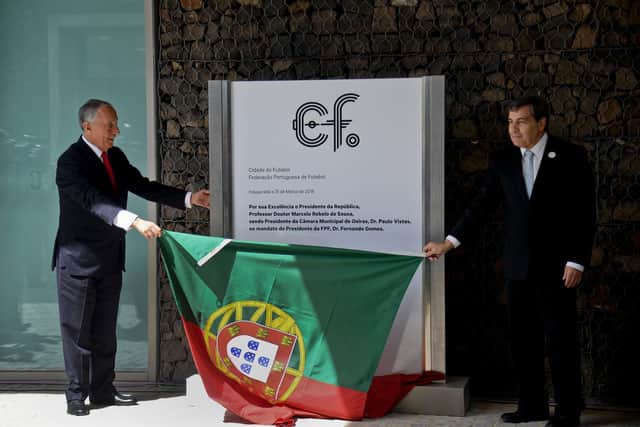 Portuguese President Marcelo Rebelo de Sousa (L) and  President of Portuguese Football Federation Fernando Gomes (R) hold a Portugeuse flag during an inaugural visit to the new training center for Portugal's football national team: PATRICIA DE MELO MOREIRA/AFP via Getty Images