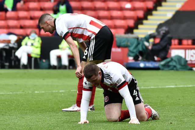 Chris Basham and John Fleck of Sheffield United look dejected after conceding their side's second goal scored by Eberechi Eze of Crystal Palace  (Photo by Rui Vieira - Pool/Getty Images)