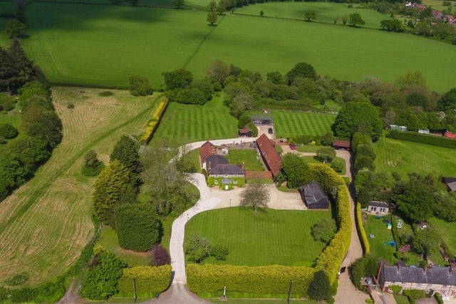 The property is set in approximately six acres of grounds, which include a large lawned garden, an orchard with a pond, and a fully restored barn which is used as a garage.