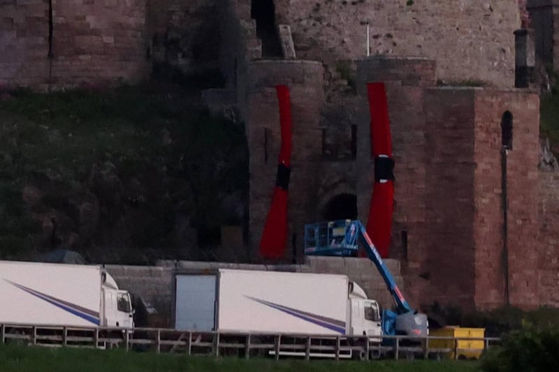 Banners on Bamburgh Castle and production lorries.