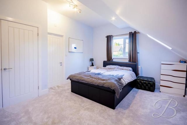 It's hard to know which bedroom to look at first, but let's start with the master. It has fitted wardrobes, a carpeted floor, Velux windows to the side and a porthole window at the front.