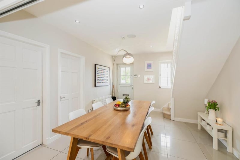 A double-glazed door to the front opens into the spacious dining entrance hall. This versatile contemporary styled space opens into the kitchen at the rear of the property. The open-plan area runs through the heart of the property and has tiled electric under floor heating throughout. A staircase with a double-glazed, leaded window leads up to the first-floor accommodation.