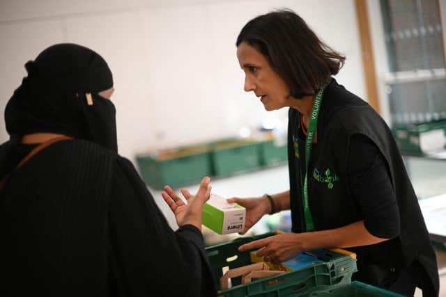 In Sheffield, 24,060 under-16s are living in absolute poverty, some 22.7 per cent of the population of that age. Pictured here, a member of staff speaks with a member of the public inside a foodbank in Hackney, north-east London (Photo by DANIEL LEAL/AFP via Getty Images)