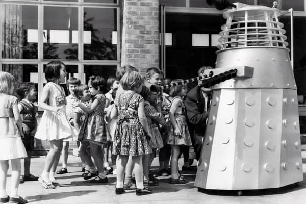 The children of the Maud Maxfield School, Sheffield, enjoy a visit from a Dalek, built by Thomas Ward and Sons Limited, in the playground of the school in 1965
