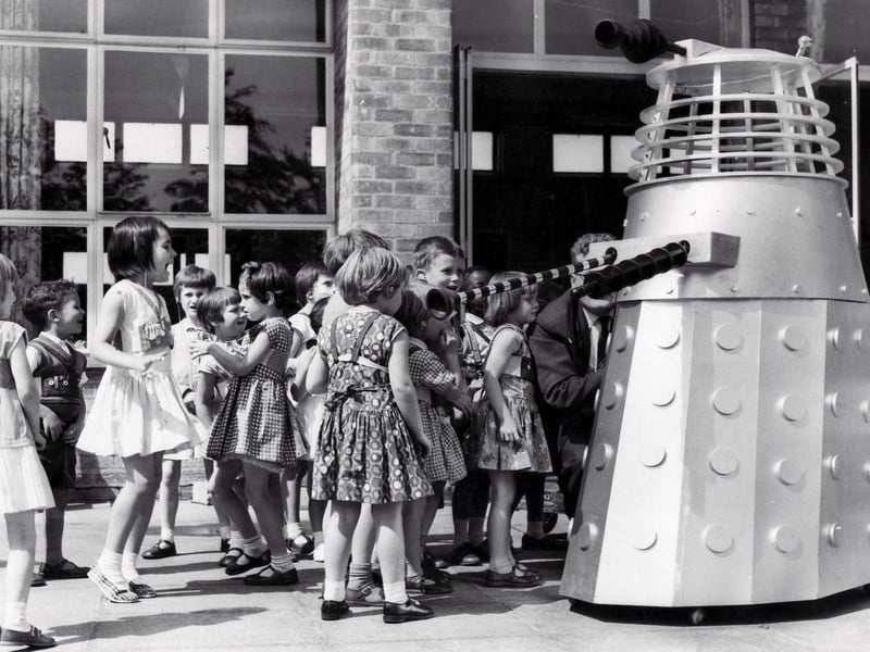 The children of the Maud Maxfield School, Sheffield, enjoy a visit from a Dalek, built by Thomas Ward and Sons Limited, in 1965