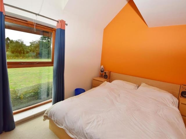 The third bedroom is smart and comfortable. It looks out on to the front of the Windmill Hill property and features an upright radiator, vaulted ceiling and built-in wardrobe.