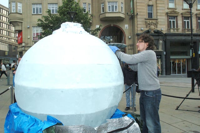 Ice sculptor Jamie Hamilton carving an ice globe for World Environment Day 2007 on Fargate