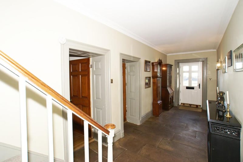 The reception hallway has original stone flags to the floor, a staircase rising to the upper-floor accommodation, central heating radiator with radiator cover, original cornice to the ceiling, wall lamp points, and a telephone point.