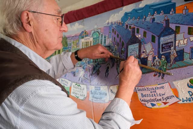 Artist Joe Scarborough working on his latest projects on his boat in Sheffield Canal Basin.