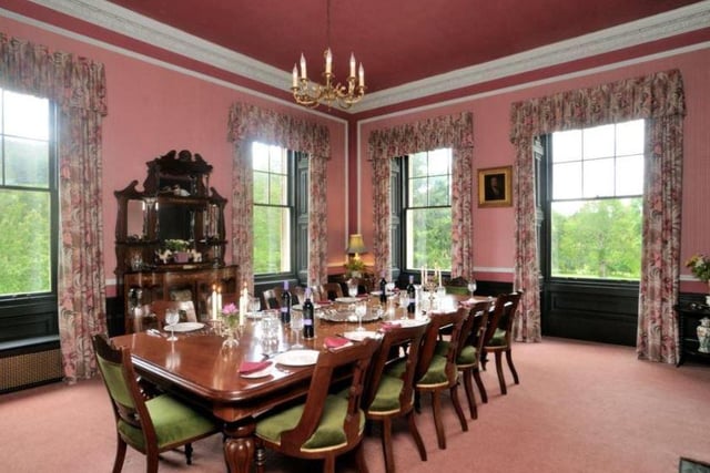 The dining room is equally grand, with a central table to accommodate up to 12 people, large surrounding windows and a chandelier overhead.