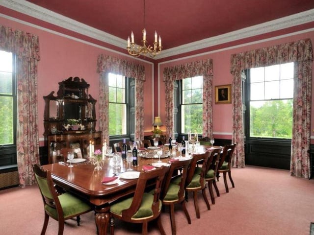 The dining room is equally grand, with a central table to accommodate up to 12 people, large surrounding windows and a chandelier overhead.