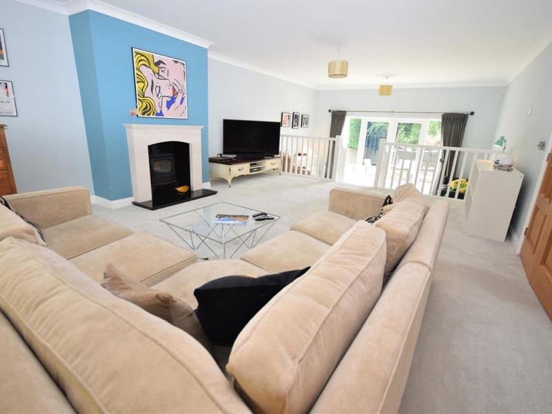 This large, modern and stylish living room has plenty of space to relax. A multi-fuel stove adds a homely feel among the contemporary touches.