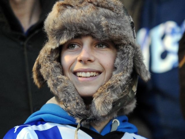 A young Sheffield Wednesday fan cheering on the Owls against Barnsley in 2010